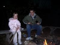 Audrey and Brett sitting around the fire roasting mellows in the secret fire pit @ Matt's